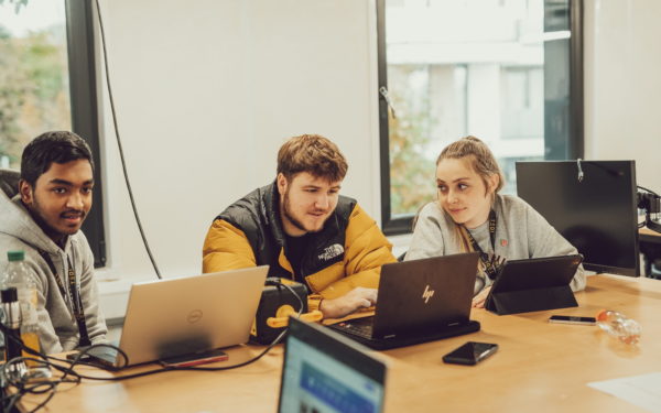 TEDI-London students researching on laptops