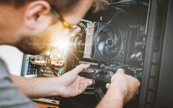Stock image - man repairing a computer